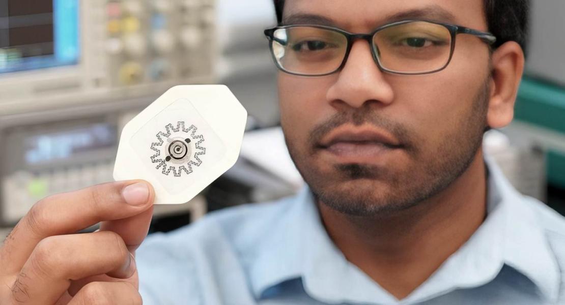 Foto del ricercatore Rajaram Kaveti che tiene in mano la medicazione WPED, alimentata ad acqua e priva di componenti elettronici, per la stimolazione elettrica delle ferite.
